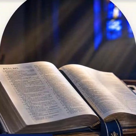 An open Bible on a lectern in soft church light